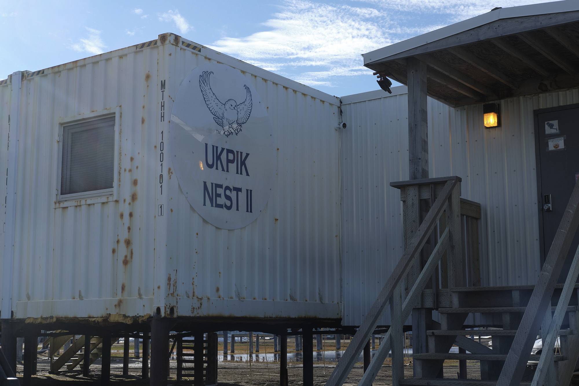 The ukpik II nest, a white building made from cargo containers